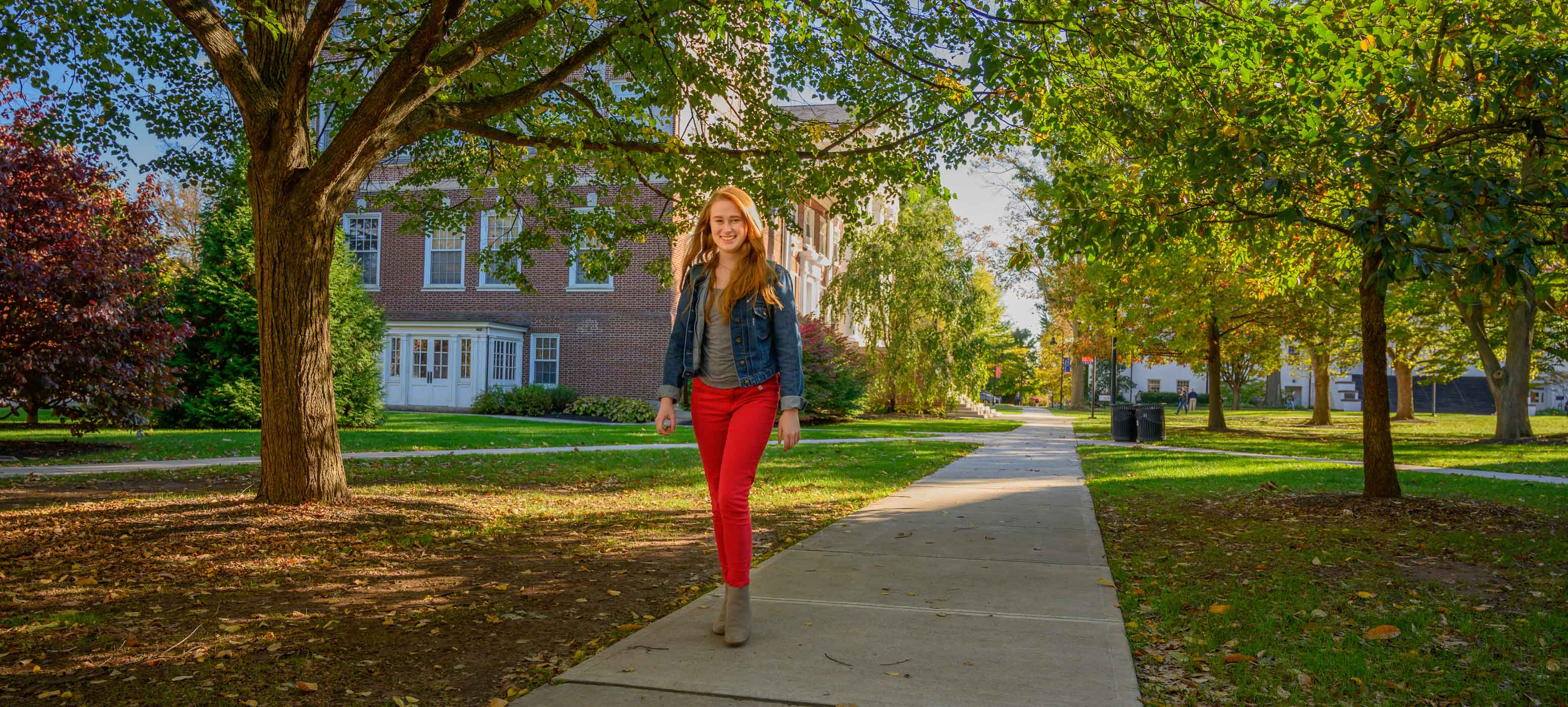 Caroline Cuetara posing on a walkway on campus