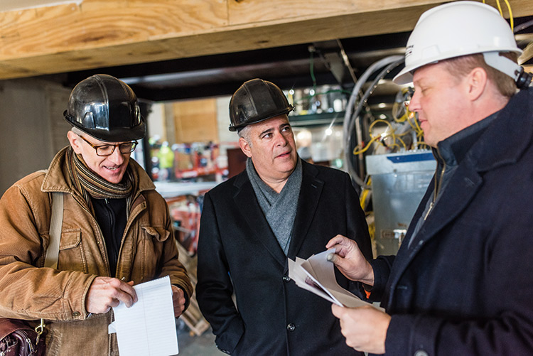 No detail escapes Fuerstman (center) and Project Manager David Hoffman (right) on site with writer Christopher Hann.