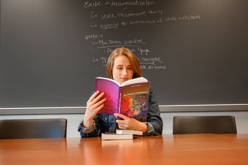 Caroline Cuetara reading a book in a classroom