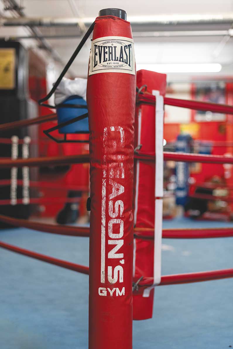 Boxing ring post with faded Gleasons logo on it