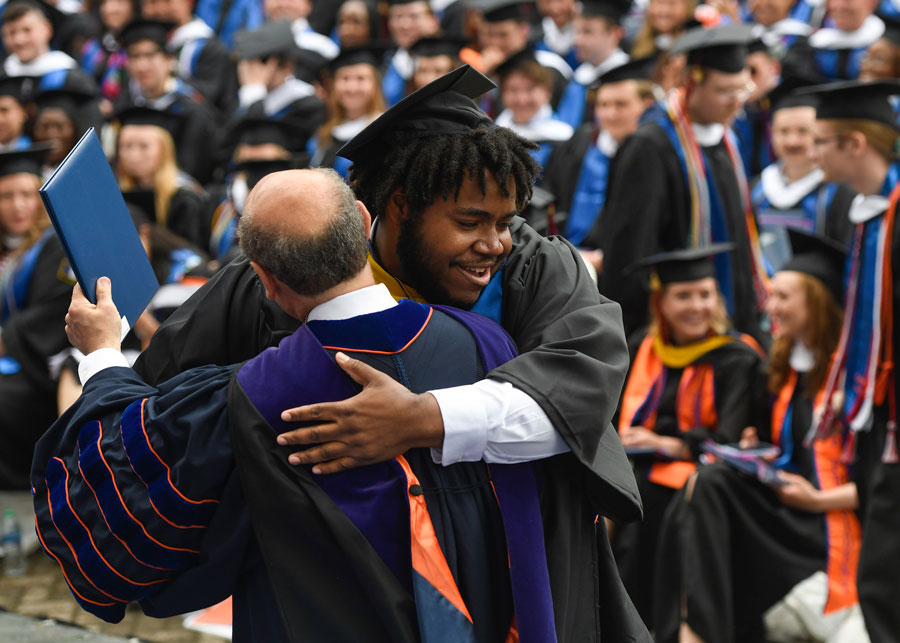 Graduate hugging Bob Iuliano