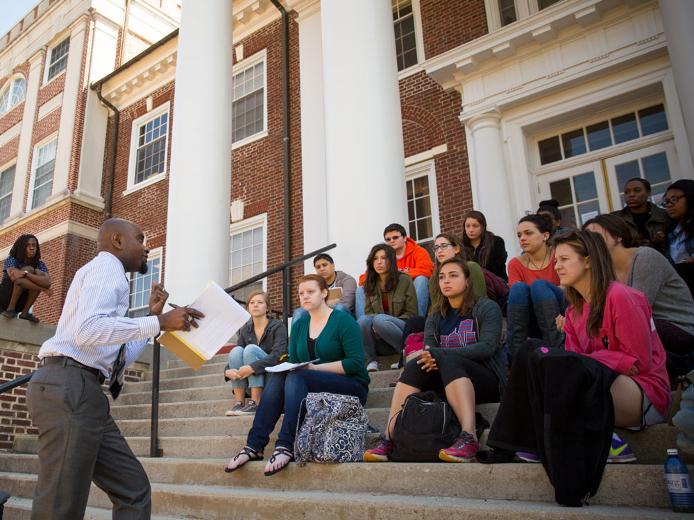 Prof. Williams teaches class on the steps of Weidensall Hall