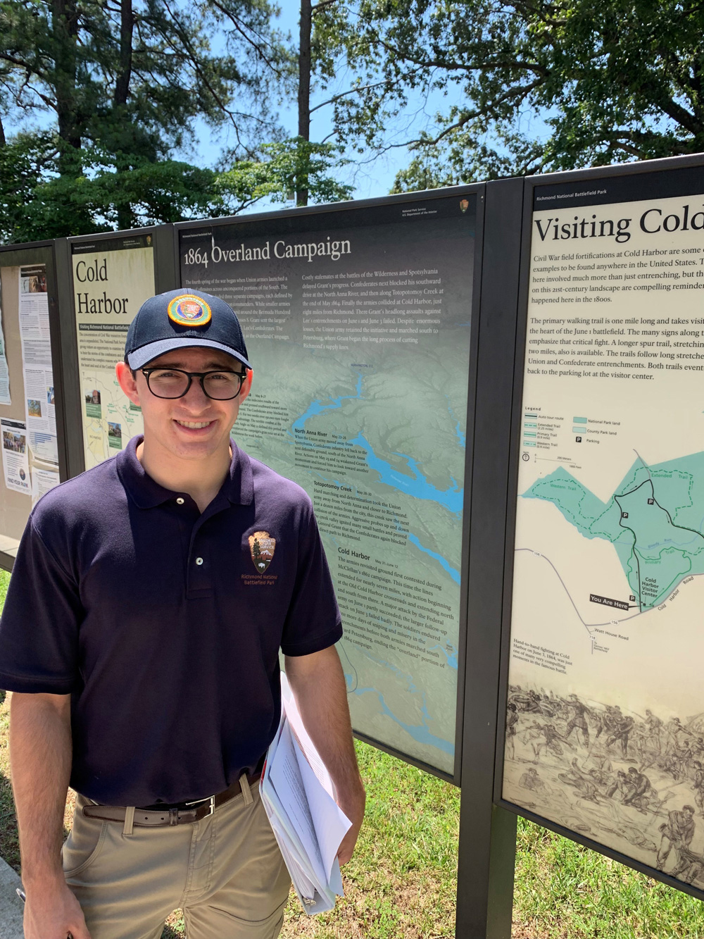 Sean Thompson standing in front of a sign in Cold Harbor National Battlefield Park